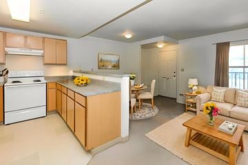 Vail apartment for rent - A kitchen with a white stove and wooden cabinets.