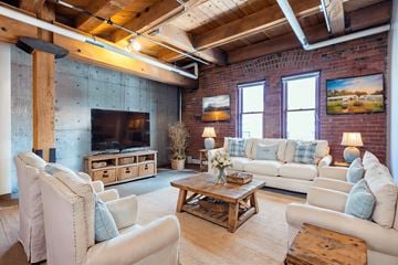 Denver apartment for rent - A living room with a white couch and a wooden coffee table.