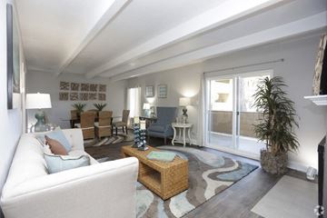 Colorado Springs apartment for rent - A living room with a white couch and a wooden coffee table.