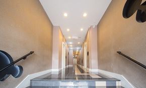East Orange apartment for rent - a long hallway with black railings and a glass floor