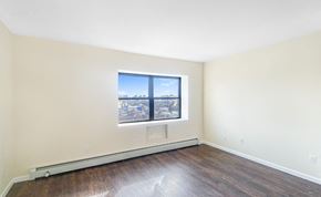 Bronx apartment for rent - an empty room with wood floors and a window