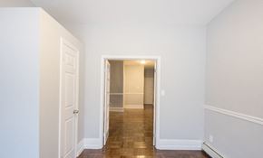East Orange apartment for rent - a bedroom with white walls and a door and a hallway to a closet
