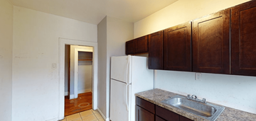 East Orange apartment for rent - a kitchen with a sink and a refrigerator and a door to a hallway