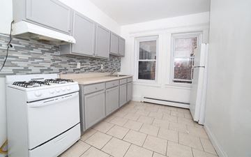 East Orange apartment for rent - a white kitchen with a stove and a window