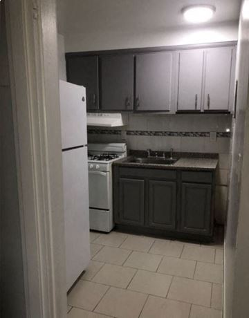 Irvington apartment for rent - a kitchen with a stove refrigerator and sink
