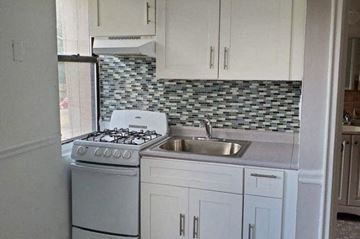 East Orange apartment for rent - a white kitchen with a stove and a sink