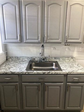 Irvington apartment for rent - A kitchen with a sink and cabinets.