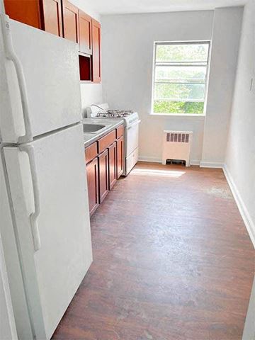 East Orange apartment for rent - a kitchen with a white refrigerator and a window