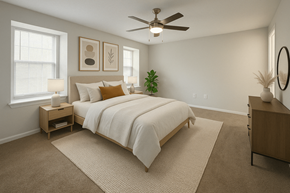 Doraville apartment for rent - A bedroom with a large bed and a ceiling fan.