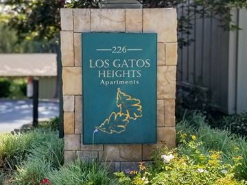Los Gatos apartment for rent - A sign for Los Gatos Heights Apartments is displayed in front of a building.
