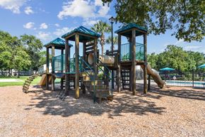 Jacsksonville apartment for rent - A playground with a wooden structure and a slide.