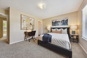 Jacsksonville apartment for rent - A bedroom with a large bed and a chair.