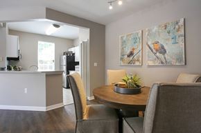Savannah apartment for rent - A dining room with a table and chairs and two pictures of birds on the wall.