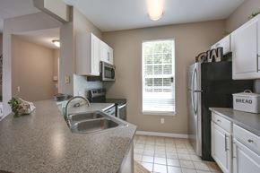 Savannah apartment for rent - A kitchen with a granite counter top and white cabinets.