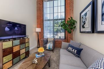 Manchester apartment for rent - A living room with a grey couch and a wooden coffee table.