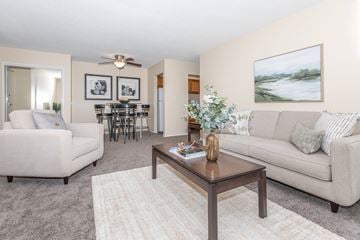 Rocky Hill apartment for rent - A living room with a white couch, a coffee table, and a painting on the wall.