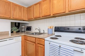 New London apartment for rent - A kitchen with wooden cabinets and a white oven.