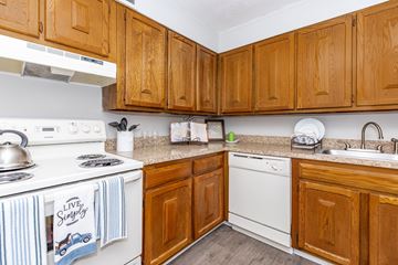 Middletown apartment for rent - A kitchen with wooden cabinets and a white stove top.