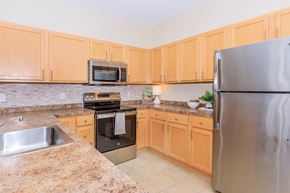 Manchester apartment for rent - A kitchen with wooden cabinets and granite countertops.