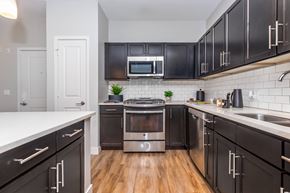 Norwalk apartment for rent - A modern kitchen with dark cabinets and stainless steel appliances.