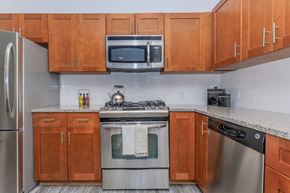 Stamford apartment for rent - A kitchen with wooden cabinets and stainless steel appliances.