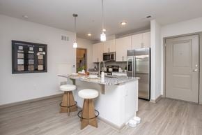 Jacksonville apartment for rent - A kitchen with a white counter and stools.