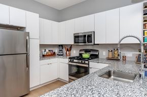 Bloomfield apartment for rent - A kitchen with a stainless steel refrigerator and a granite countertop.