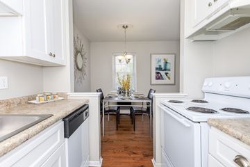 Naugatuck apartment for rent - A kitchen with white cabinets and a large island with a marble countertop.