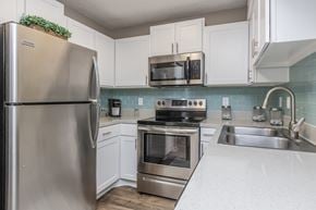 Atlantic Beach apartment for rent - A kitchen with a stainless steel refrigerator and white cabinets.