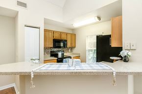 Jacksonville apartment for rent - A kitchen with a table set for a meal.