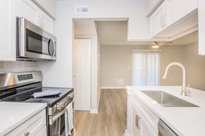 Brooksville apartment for rent - A kitchen with white cabinets and a stainless steel microwave.