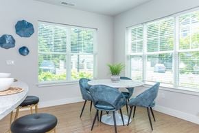 Simsbury apartment for rent - A dining room with a white table and blue chairs.