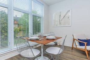 Norwalk apartment for rent - A dining room with a table set for two and a couch.