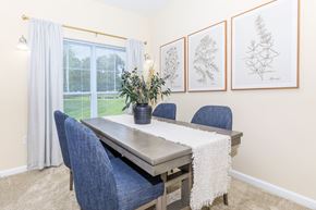 Manchester apartment for rent - A dining room with a table, chairs, and pictures on the wall.