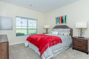 Manchester apartment for rent - A bedroom with a bed, nightstand, and lamp.