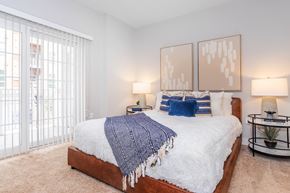 Norwalk apartment for rent - A bedroom with a large bed and two lamps.