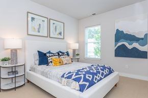 Simsbury apartment for rent - A bedroom with a large bed and two framed artworks on the wall.