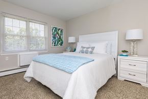 Naugatuck apartment for rent - A bedroom with a white bed and a blue pillow.