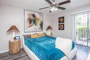 Orlando apartment for rent - A bedroom with a large bed and a ceiling fan.