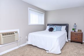 East Haven apartment for rent - A bedroom with a bed, nightstand, and window.
