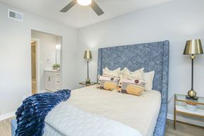 Brooksville apartment for rent - A bedroom with a large bed and a ceiling fan.