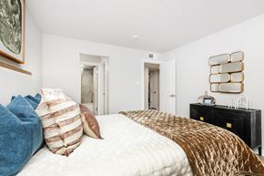 St. Petersburg apartment for rent - A bedroom with a large bed and a black dresser.