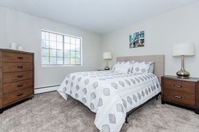 Waterbury apartment for rent - A bedroom with a bed, nightstand, and lamp.