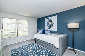 Bradenton apartment for rent - A bedroom with a large bed and a fish picture on the wall.