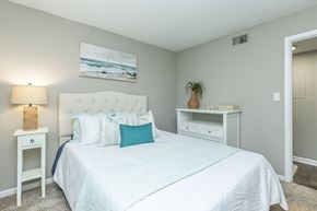 Atlantic Beach apartment for rent - A bedroom with a large bed and a painting on the wall.