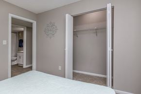 Atlantic Beach apartment for rent - A bedroom with a white bed and a closet with a white door.