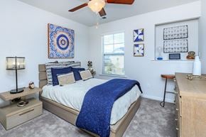 Savannah apartment for rent - A bedroom with a bed, a ceiling fan, and a rug.