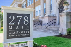 West Haven apartment for rent - A sign for 278 Main Giannotti Apartment Homes in front of a building.