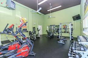 East Haven apartment for rent - A gym with a variety of equipment including treadmills, weights, and a fan.