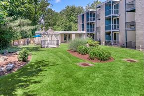 East Haven apartment for rent - A well-maintained lawn in front of a building with a gazebo.